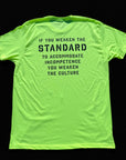 Bright yellow t-shirt with black text on a black background