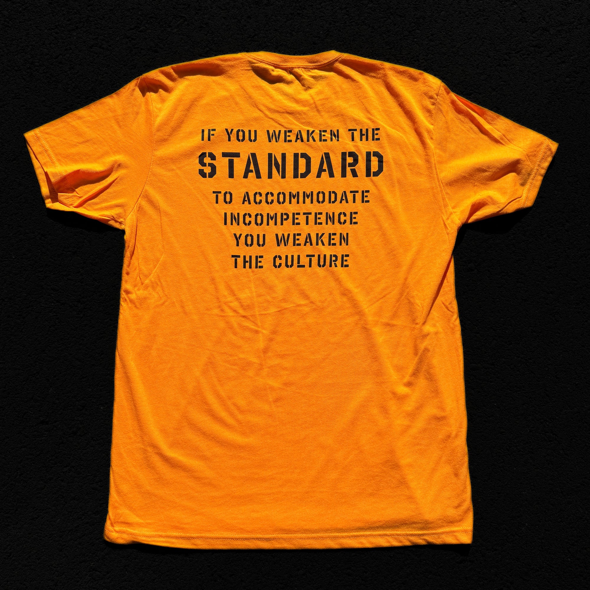 Orange t-shirt with black text on a black background