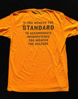 Orange t-shirt with black text on a black background