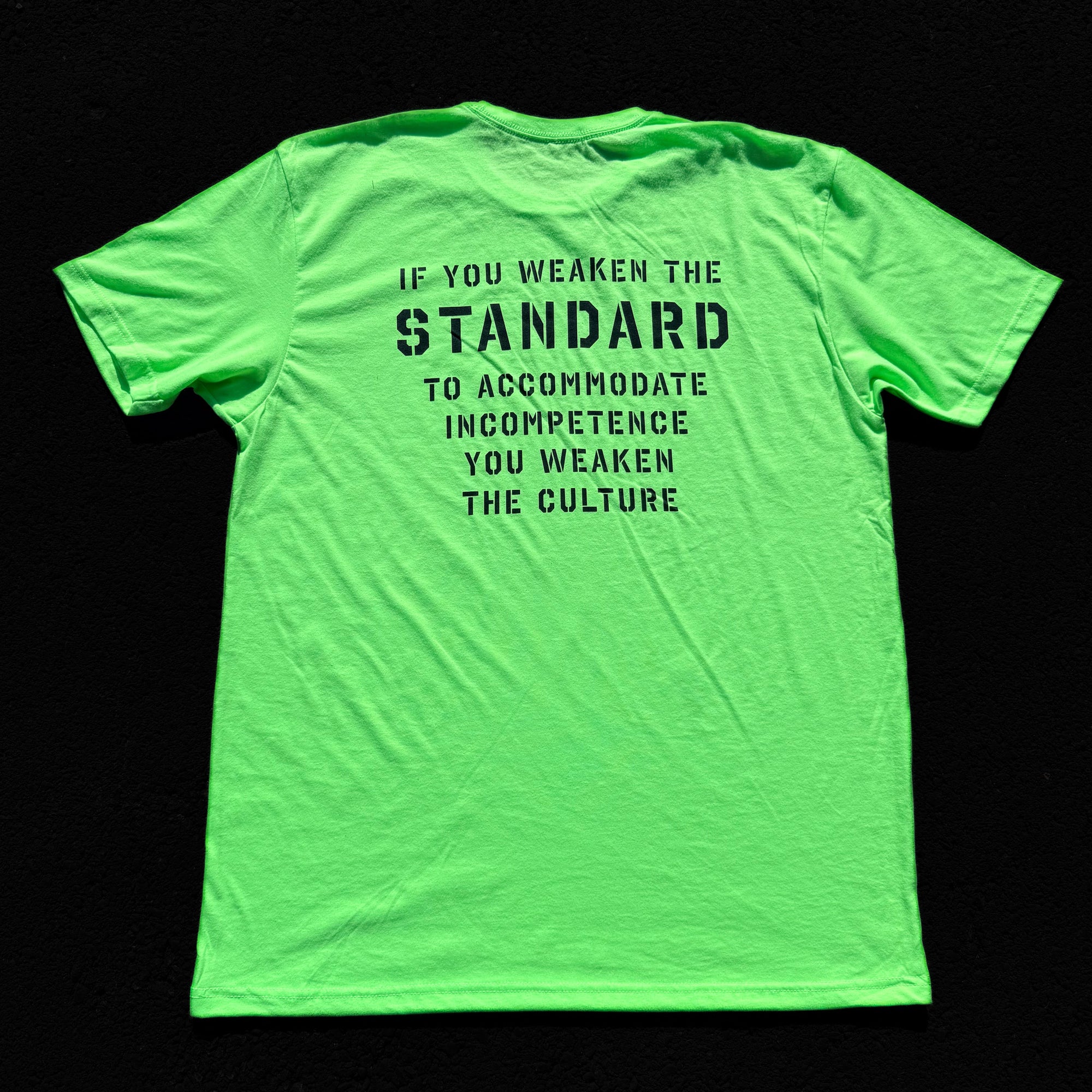 Green t-shirt with black text on a black background