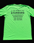 Green t-shirt with black text on a black background
