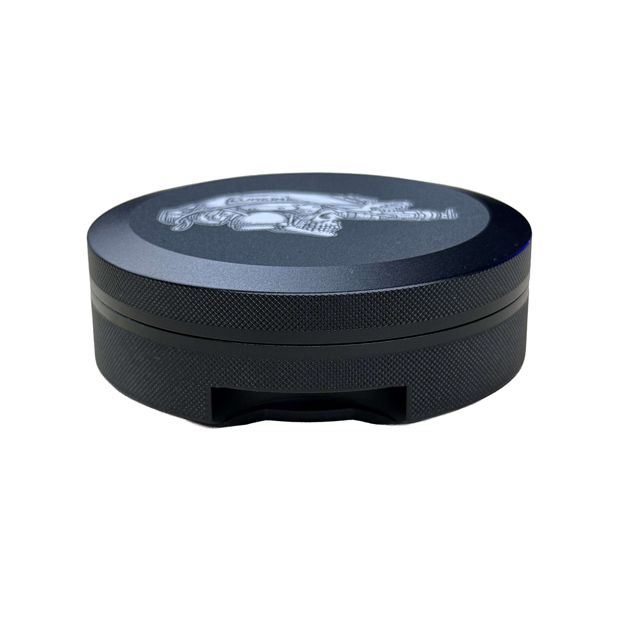 A round black metal container with a textured grip and a silver logo on top, shown against a plain white background.
