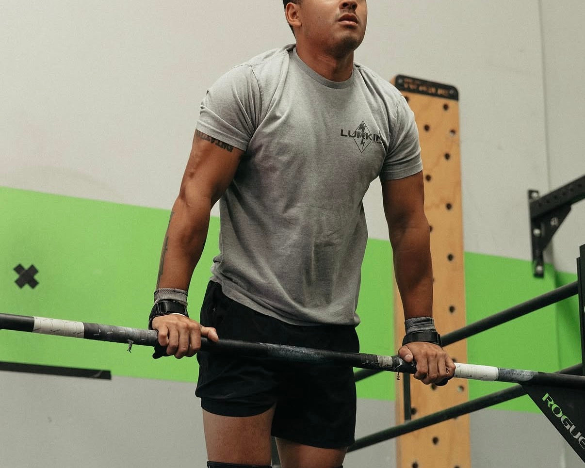 Man lifting a barbell in a gym setting
