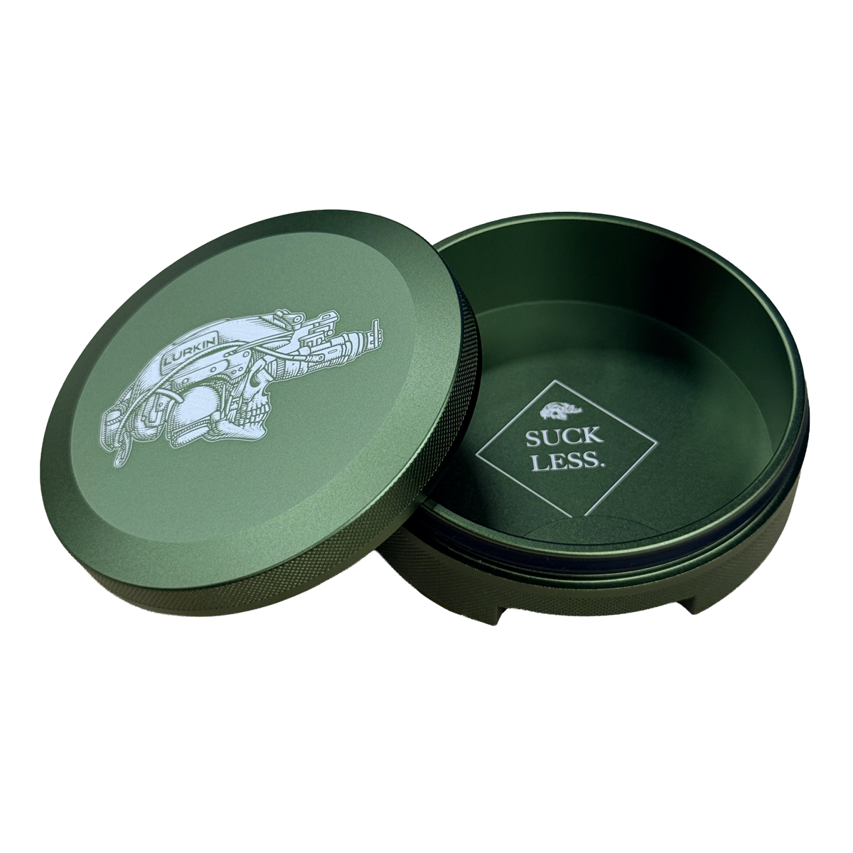 A olive drab round metal tin with its lid leaning against it on a white background. The lid features a graphic of a logo while the inside of the tin is also olive drab with a logo that reads 'SUCK LESS.